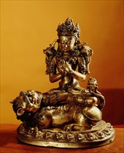 A statue of Manjusri, Bodhisattva of Wisdom, with the sword that destroys ignorance on the lotus at his right shoulder, and the book of wisdom at his left