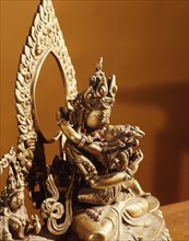 The Supreme Buddha Vajradhara in union with the Supreme Knowledge of the Void, flanked by two other Wisdoms