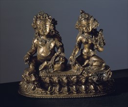 A statue of Jambhala   also called Vaisravana   and his consort