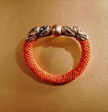 Tibetan coral bracelet with silver dragon head terminals