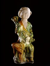 Tomb figure of a foreign woman holding a wine ewer in the form of a goose