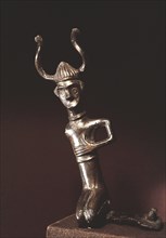 A deity in the form of a figure wearing a horned helmet