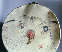 Shield cover decorated with a turtle, a thunderbird, stars and the milky way