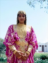 Young woman wearing an elaborate silver headdress and jewellery of the type used for wedding ceremonies