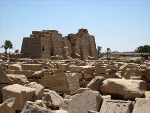 View of the 7th Pylon, built by Tuthmosis III and with the remains of two seated colossi of the pharaoh in front