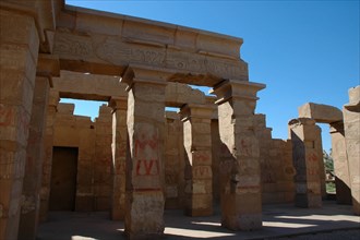 Partially reconstructed temple in the Open Air Museum area of the Precinct of Amun, showing red-painted scenes on the columns