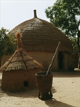 A woman's house with a granary in the foreground in a Hausa village compound