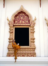 Boy monk dressed in saffron robes at the Wat Chedi Luang Monastery