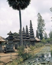The water around the pagoda roofed shrines at the Pura Taman Ayun recalls the primeval ocean from which the cosmic mountain, Mount Meru, symbolized by the shrines, formed the levels of the cosmos
