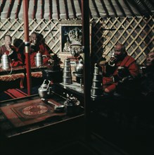 High ranking lamas during tea ceremony, in their yurt attached to the temple