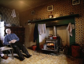 A retired seaman in the living room of his croft