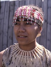 A Fijian girl living in Auckland, wearing a modern beaded headdress and necklace