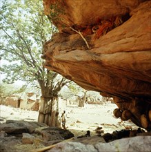 Niches at the base of the high cliffs above the village are used to store sacred masks and drums