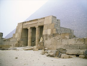Near the southeast corner of the pyramid of Cheops stands the restored columned portico of the family tomb of Seshemnefer