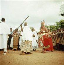 The late Oba Akenzua II in full regalia, with members of his court