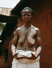 The wife of a Benin chief displays her body decorations