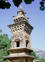 A stone pagoda with ornate relief carved facade, near the Cliff of the Thousand Buddhas at Qianfoyan