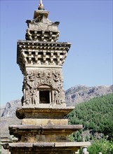 A stone pagoda with ornate relief carved facade, near the Cliff of the Thousand Buddhas at Qianfoyan