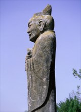 A monumental stone carving of an official wearing a Confucian-style hat