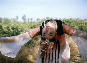Uygur girl, a professional dancer dressed for the grape harvest dance