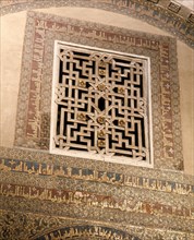 The grille and calligraphy in mosaic above the doorway to the treasury in the Great Mosque at Cordoba   Spain