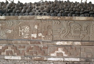 Bas relief frieze showing human skull emerging from the open mouth of Quetzalcoatl, who is represented as the Feathered Serpent
