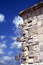 Cornice of building from Uxmal, showing the distinctive snarling mouth and curled nose of the Maya god of rain, Chac