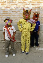 Two young boys dressed as Jaguars and one as a Fox, in the fertility and rain making festival dating from the pre-Columbian times