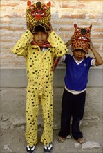 Two boys dressed as jaguars, in a fertility and rain making festival dating from the pre-Columbian times