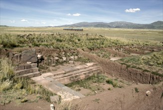 Temple architecture emerging from the soil at the Puma punku sector of Tiahuanaco (Tiwanaku)