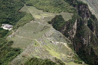 The view of Machu Picchu from the summit of Huayna Picchu shows the dramatic location of the city and its terrace system
