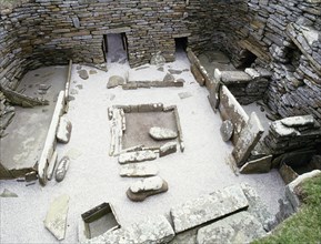 The interior of House 1, view of the hearth and the beds