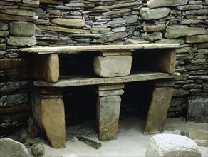 View of the massive stone built version of the old "farmhouse dresser", situated opposite the entrance of the House 1