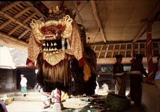 In the storehouse of the temple offerings are made to the spirits drawn into the masks