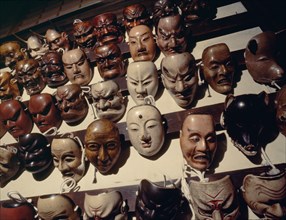 Kyogen masks set out on racks for use during performances