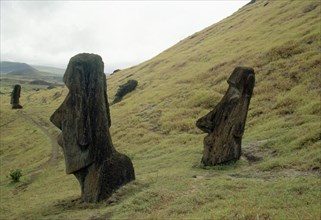 Moai statues, buried up to their necks by soil creep, on the slopes of the volcanic quarry Rano Raraku