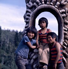 Three Indian boys at the 'Hole-in-the-Sky' pole