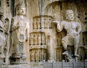The guardian kings of Buddhism carved on the north wall of the Fengxian temple at the Longmen cave-temple complex