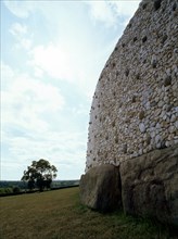 View of the stone walls that surround the heart-shaper mound covering the prehistoric passage tomb at Newgrange