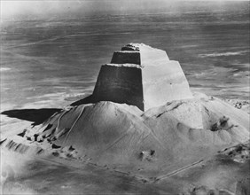 The pyramid of Meidum, surrounded by the debris of its collapsed outer covering, photographed in the 1920's