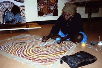 Balgo Community artist, the late Mati Mudgedell, working on a dot painting at the Warlayirti Culture Centre in the north-west desert region of Western Australia south of Halls Creek