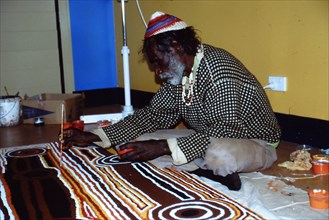 Balgo Community desert artist, the late Tjumpo Tjapanangka, working on a dot painting at the Warlayirti Culture Centre in the north-west desert region of Western Australia south of Halls Creek