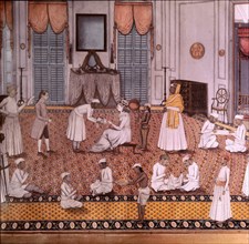 An Indian miniature showing the wife of a British officer attended by numerous servants