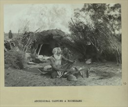 Aboriginal man carving a boomerang