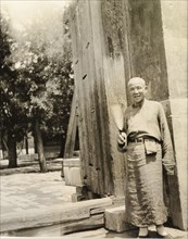 Lama priest at the doorway to a temple