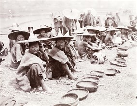 Mendicants beg by the roadside, China