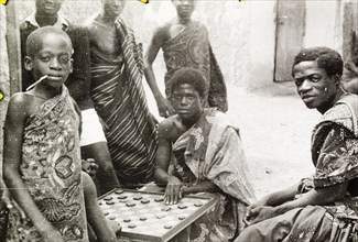 Asante boys playing a board game