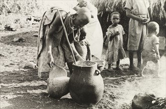 Kikuyu woman crafting pottery