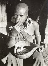 Kikuyu woman eating maize porridge