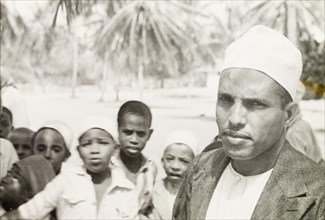 Surahi man with group of children